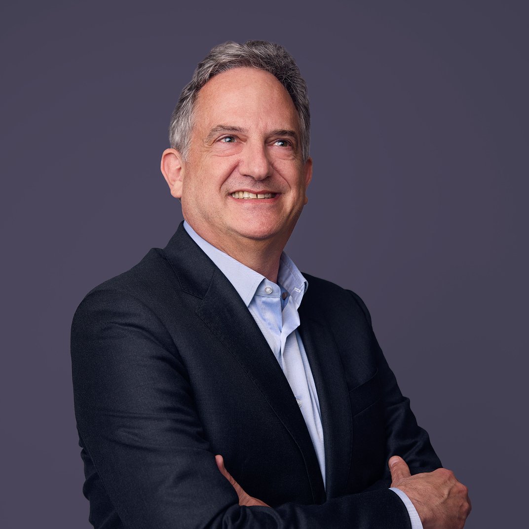 Marcus Oyelaran, COO, photographed against a purple backdrop