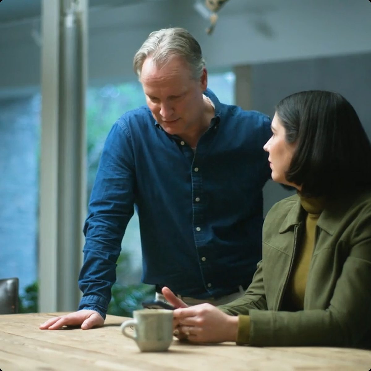 Two colleagues reviewing work together at a table